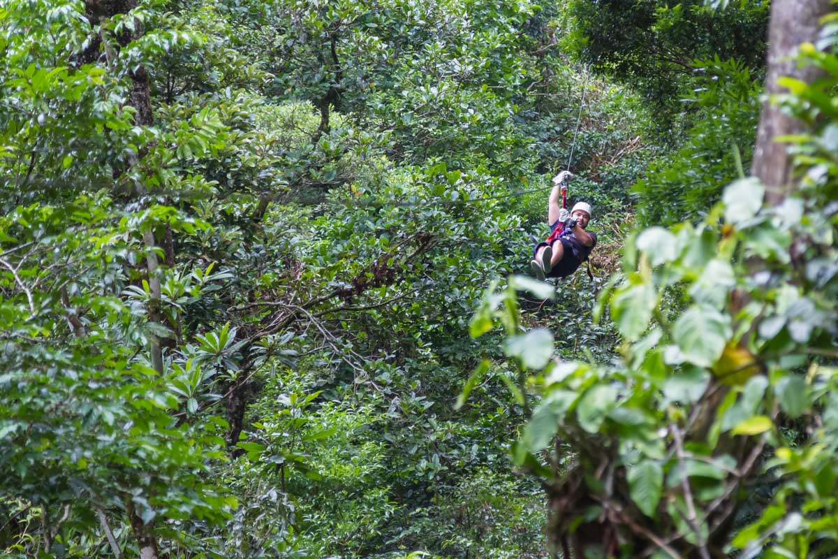 A man comes down a zipline in Jaco, Costa Rica