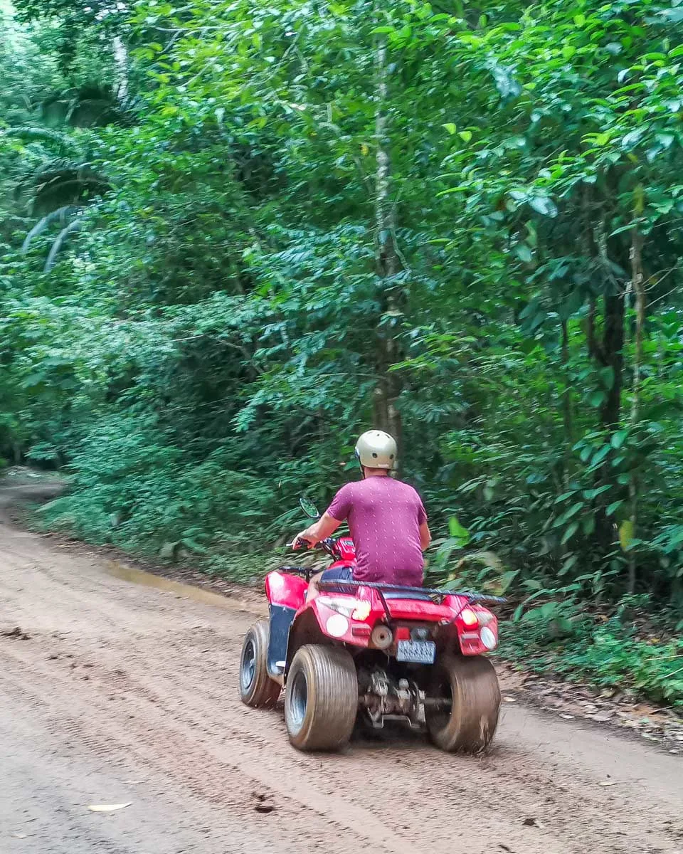 Daniel rides an ATV through the jungle near Jaco, Costa Rica
