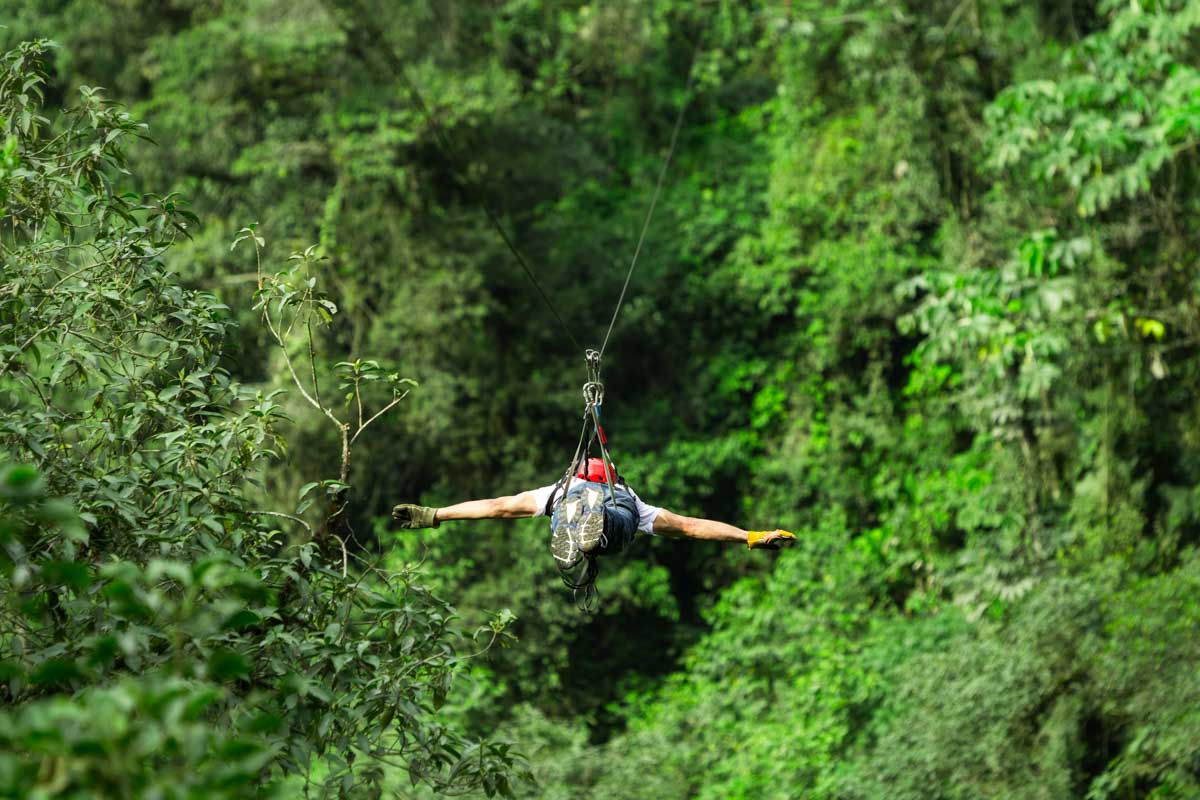 A man does a superman zipline in La Fortuna, Costa Rica
