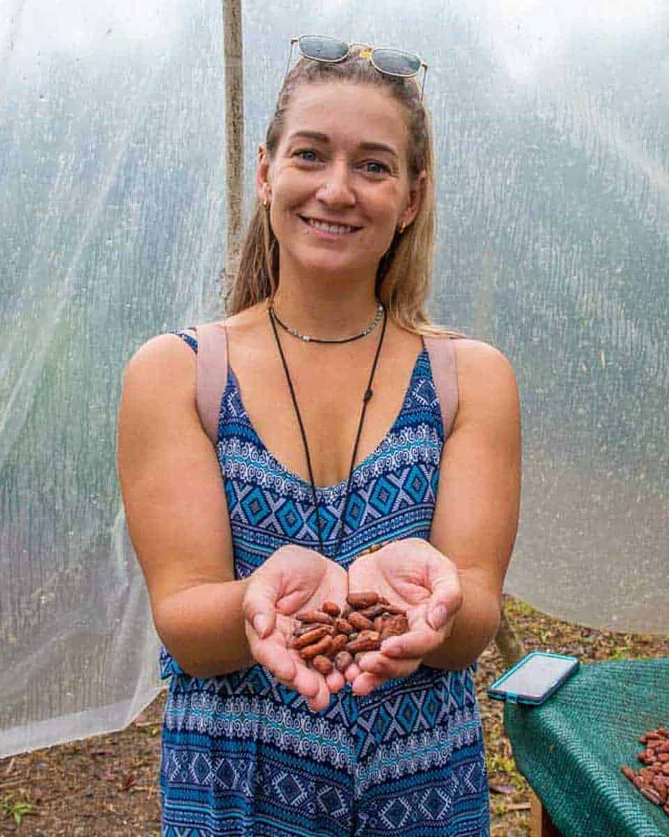Bailey hold bean on a coffee and chocolate tour in La Fortuna